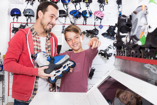 Father and son examining various roller-skates