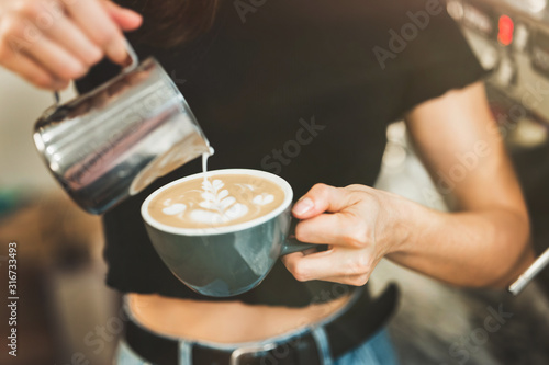 process of pouring whipped milk to hot coffee drink, barista work