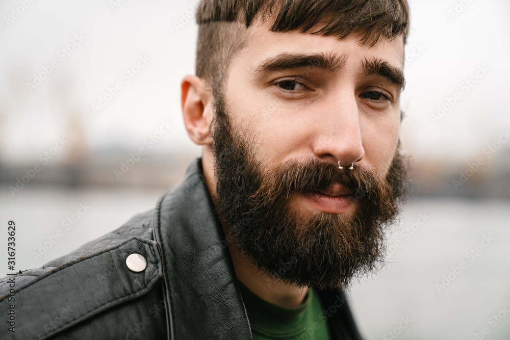 Fototapeta premium Photo closeup of bearded young man looking at camera