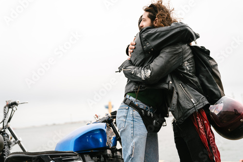 Photo of bearded young men bikers smiling and hugging
