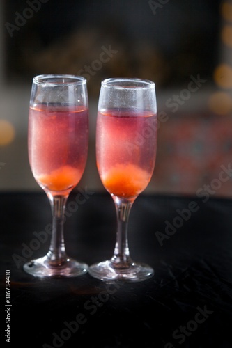 Two glasses of pink champagne for the couple.