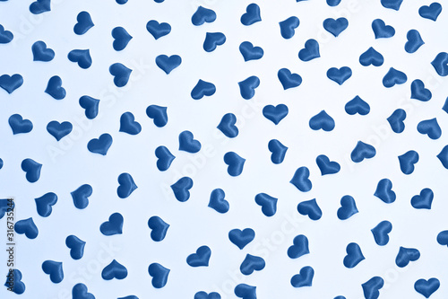Valentine s day decorative pattern blue hearts confetti on white background.