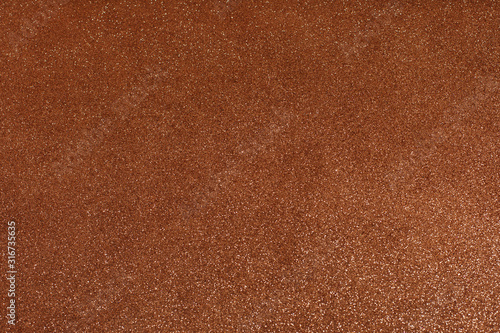 Dark gold copper glitter texture background. Brown glitter