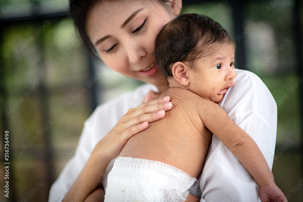 Asian parent hands holding newborn baby fingers, Close up mother's hand holding their new born baby. Love family healthcare and medical Asian parent hands holding newborn baby fingers, Close up mother's hand holding their new born baby. Love family healthcare and medical