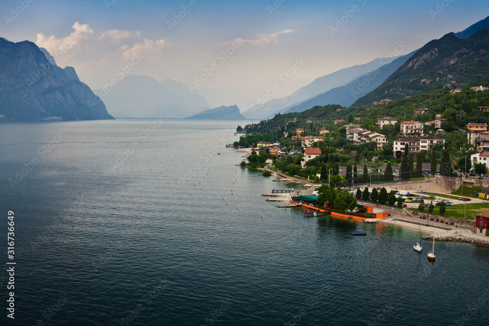 Panorama of one of the most beautiful cities on lake Garda in the province of Veneto in Northern Italy - Malcesine, view of the promenade, Scaliger castle and the Lago di Garda