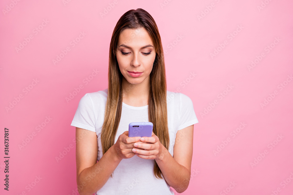 Photo of beautiful lady holding telephone hands texting with friends sending new just made selfie pictures wear casual white t-shirt isolated pink color background