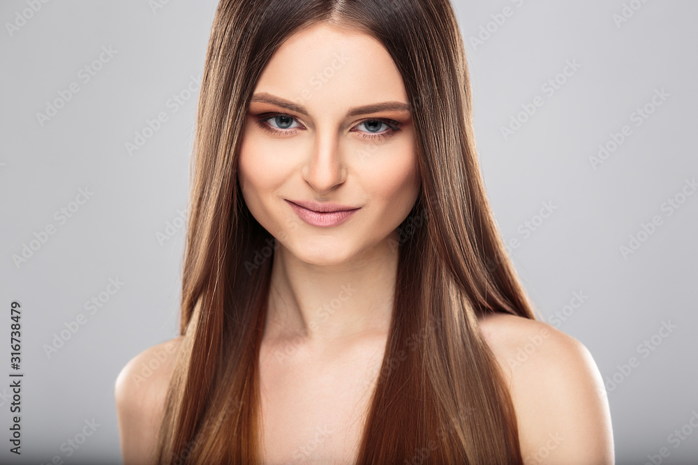 Naklejka premium Young woman with beautiful healthy long hair and natural make up. Fashion beauty portrait
