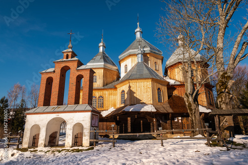 Fototapeta Naklejka Na Ścianę i Meble -  Exterior of Bystre Wooden Orthodox Church.  Bieszczady Architecture in Winter. Carpathia Region in Poland