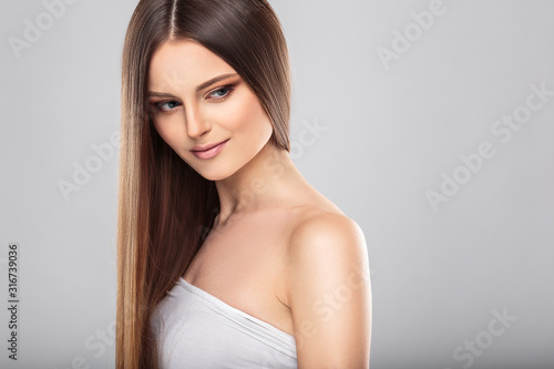 Young woman with beautiful healthy long hair and natural make up. Fashion beauty portrait