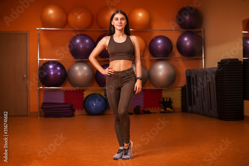 Fitness model woman. Female sportswear clothes on perfect body in gym