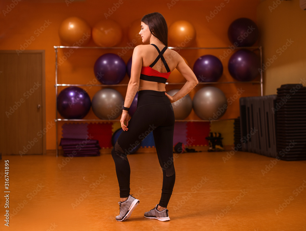 Fitness model woman. Female sportswear clothes on perfect body in gym Fitness model woman. Female sportswear clothes on perfect body in gym