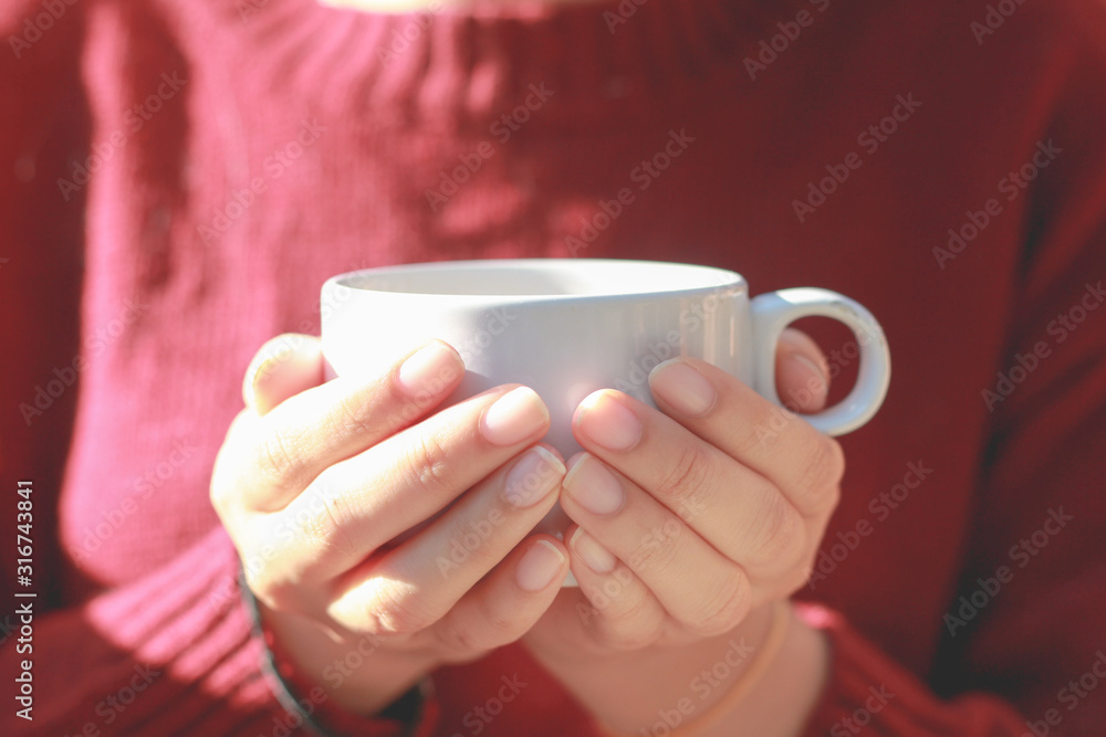Woman red sweater holding cup of coffee. Woman red sweater holding cup of coffee.
