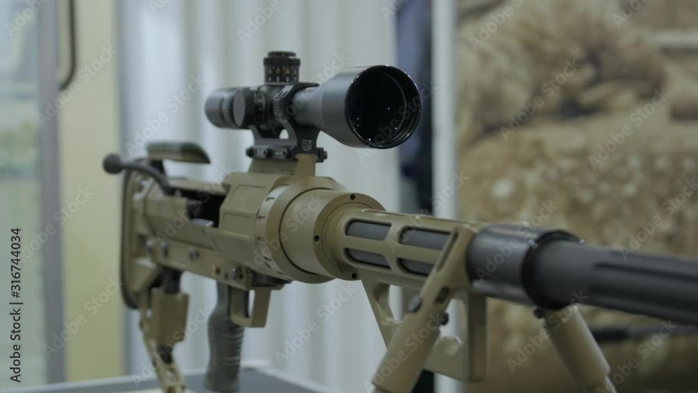 Modern sniper rifle weapon with an optical sight military green camouflage camera movement Modern sniper rifle weapon with an optical sight military green camouflage camera movement