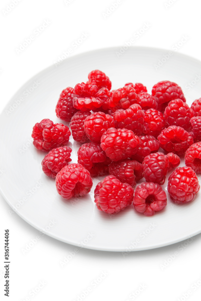 Fresh raspberries in plate against white background Fresh raspberries in plate against white background