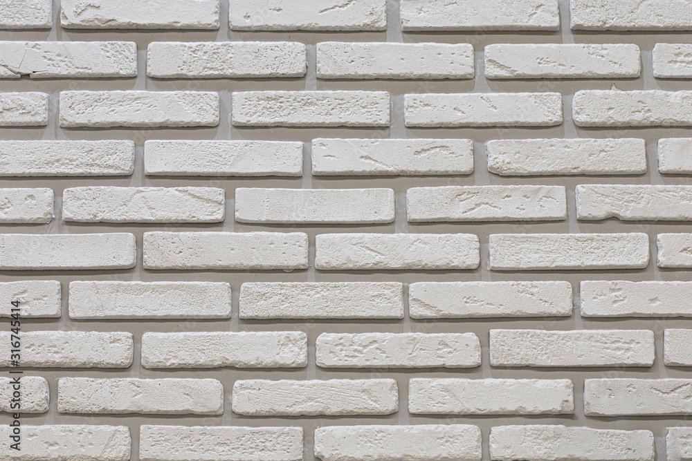 White brick wall with shabby grain brick. Decorative wall decoration with stone, backdrop texture background. Wall of white thin smooth brick texture effect White brick wall with shabby grain brick. Decorative wall decoration with stone, backdrop texture background. Wall of white thin smooth brick texture effect