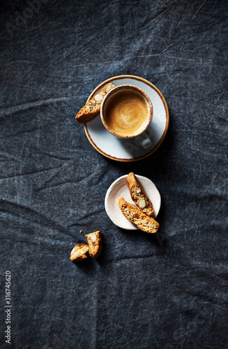 Cup of coffee with almond cookie. Top view. Copy space