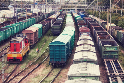 Freight trains and locomotive at a station in a railway depot