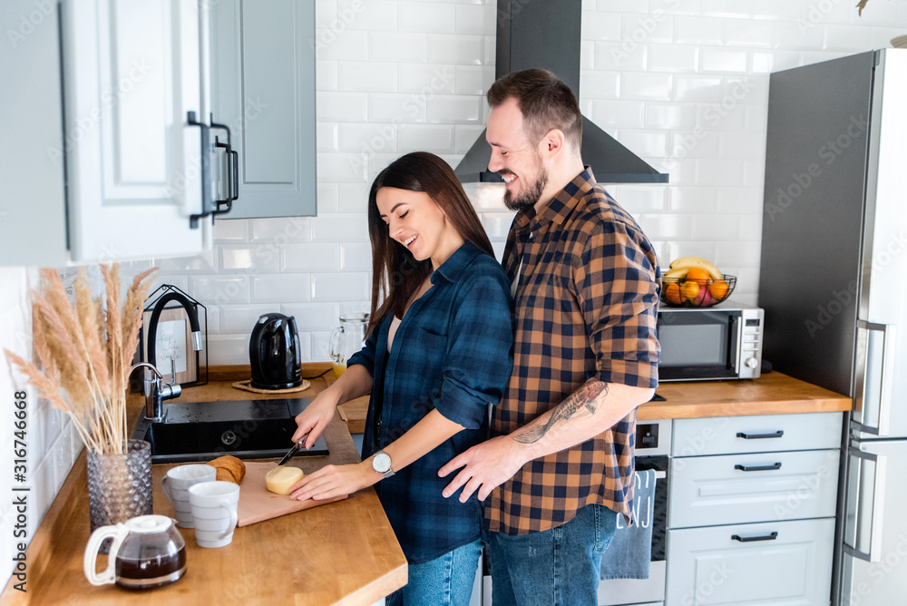 Beautiful couple in the kitchen cook together Beautiful couple in the kitchen cook together