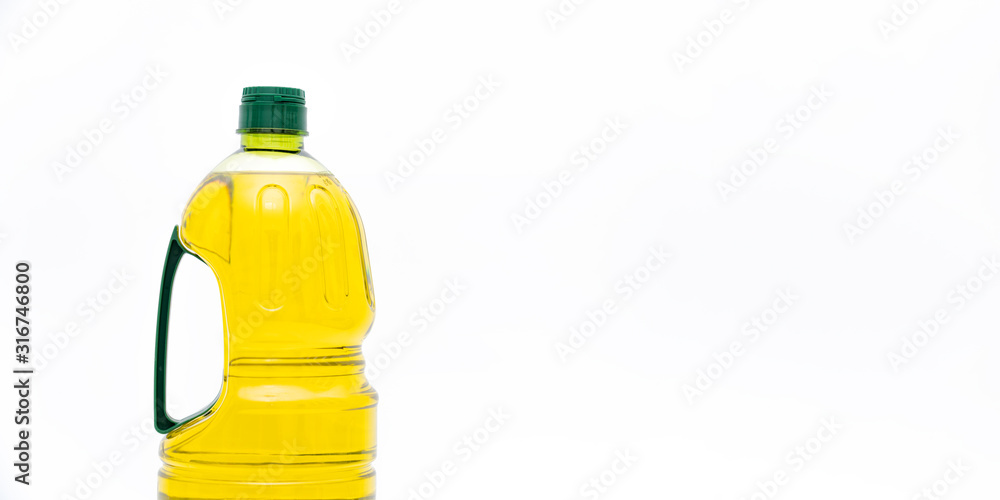 A bottle of yellow salad oil on a white background A bottle of yellow salad oil on a white background