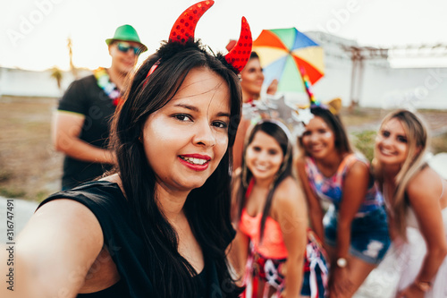 Brazilian Carnival. Group of friends in costumes taking a self portrait