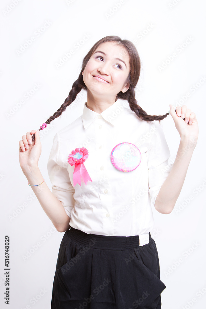 Young woman with pigtails daydreaming against white background Young woman with pigtails daydreaming against white background