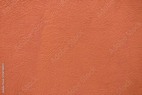 Surface background with smears of dark orange paint, close-up texture