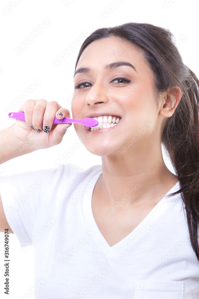 Portrait of young attractive woman brushing her teeth Portrait of young attractive woman brushing her teeth