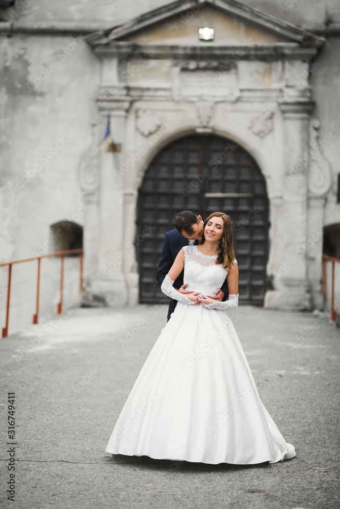 Fototapeta premium Romantic wedding moment, couple of newlyweds smiling portrait, bride and groom hugging