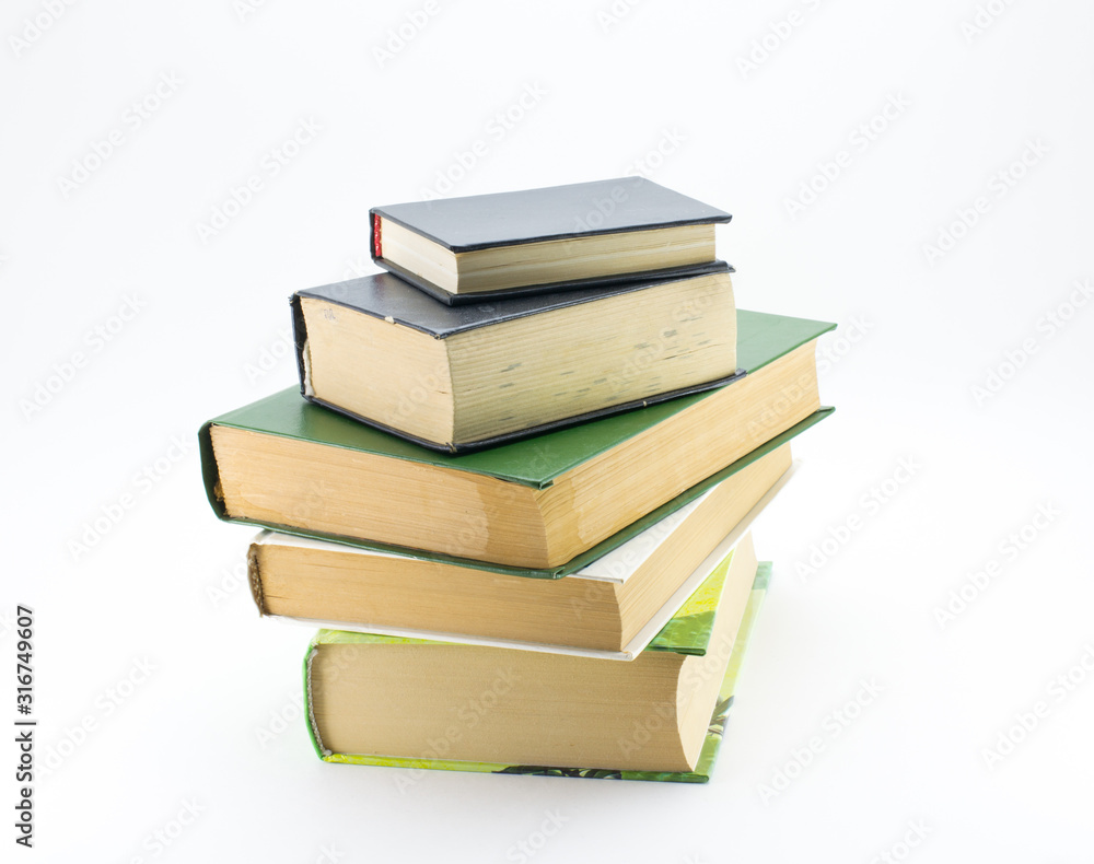 A stack of different books on a white background. A stack of different books on a white background.
