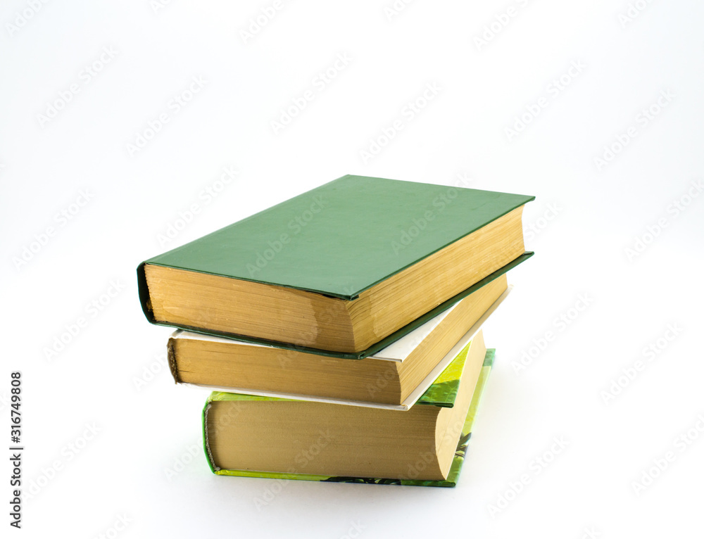 A stack of different books on a white background. A stack of different books on a white background.