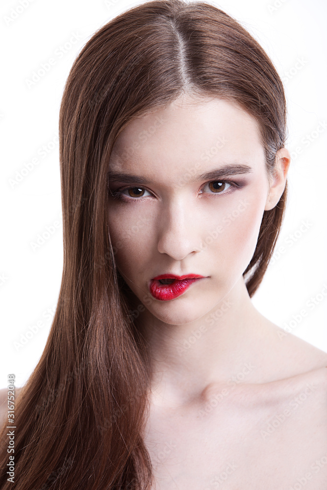 Portrait of beautiful young woman biting her lip against white background Portrait of beautiful young woman biting her lip against white background