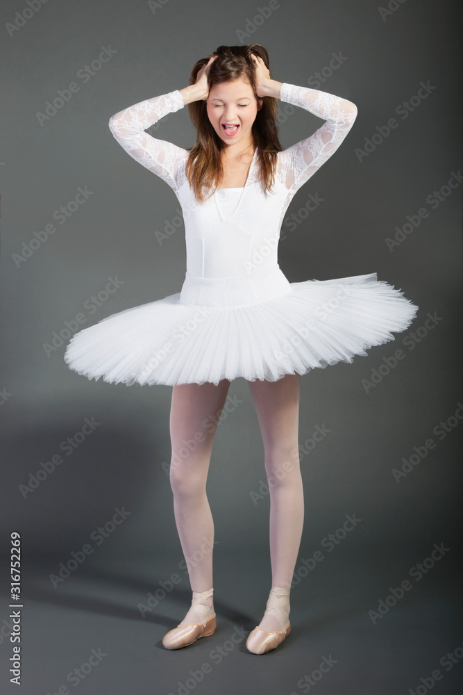 Young female ballet dancer screaming over grey background Young female ballet dancer screaming over grey background
