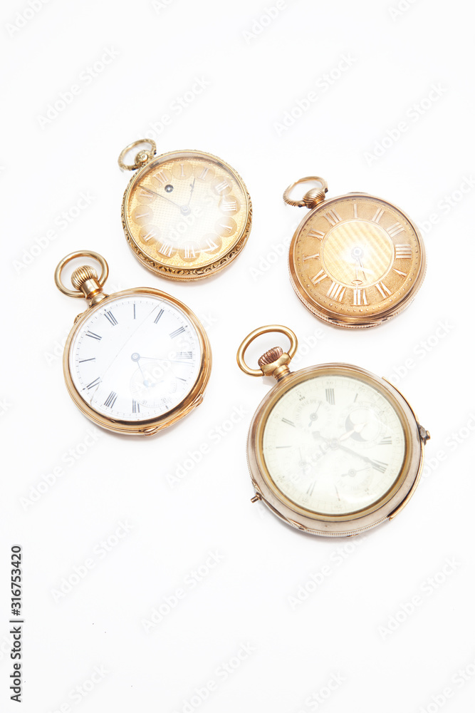 Four old-fashioned pocket watches over white background Four old-fashioned pocket watches over white background