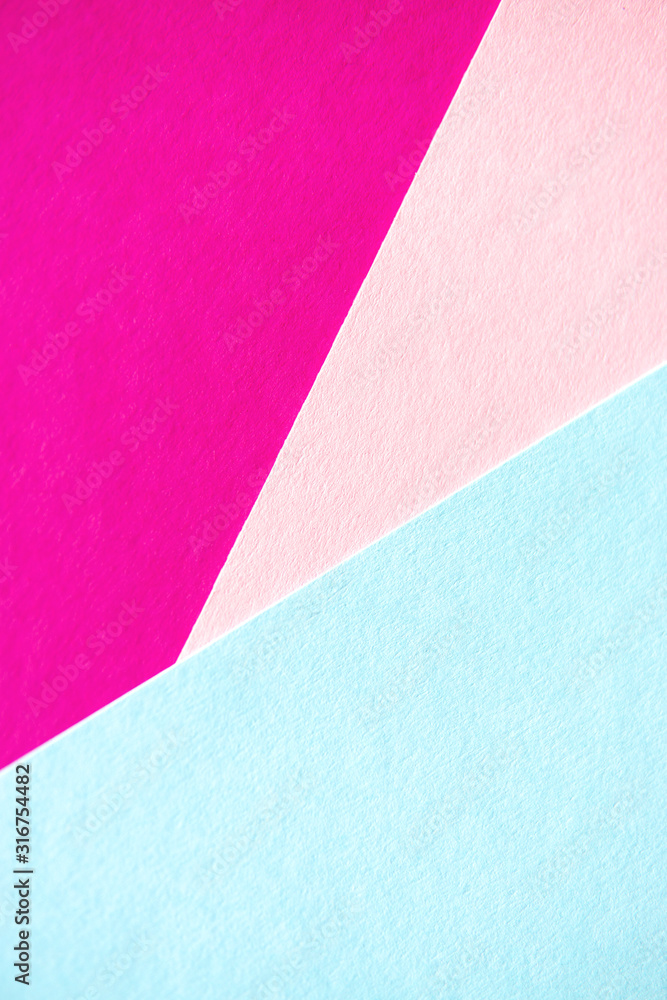 Fototapeta premium Lilac, soft pastel blue and light pink colored textured paper for the background. Geometric empty paper background of three tones for copy space.