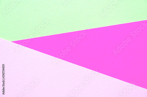 Lilac, soft pastel green and light pink colored textured paper for the background. Geometric empty paper background of three tones for copy space.