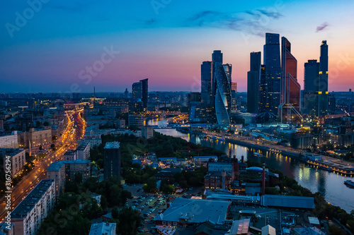 Fototapeta Naklejka Na Ścianę i Meble -  Russia. Evening Moscow. The streets of Moscow on sunset. Panorama of Moscow city. Highway in the center of the capital. The capital of Russia in the night lights. River view from Quadrocopter