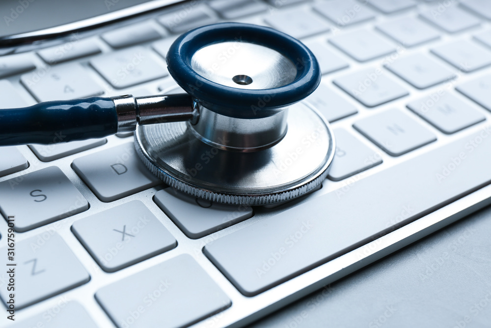 Keyboard and stethoscope on table, closeup. Concept of technical support Keyboard and stethoscope on table, closeup. Concept of technical support