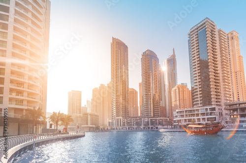 Old-fashioned wooden ferry boat cruise in Dubai Marina harbor. Tourist destinations in United Arab Emirates