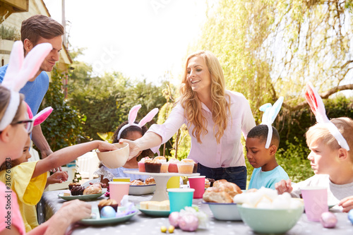 Photography Parents With Children Wearing Bunny Ears Enjoying Outdoor Easter Party In Garden