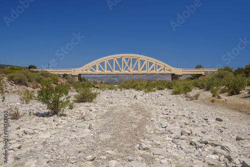 Bridge over a ragged river, Rhodes, Greece photo