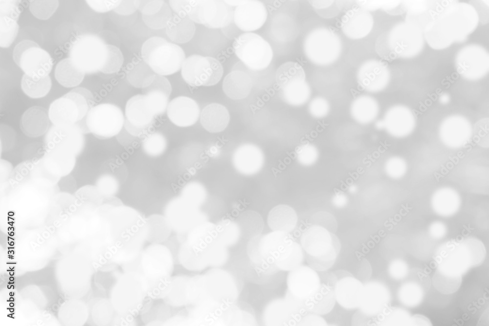 Abstract background with White bokeh on gray background. christmas blurred beautiful shiny Christmas lights. Abstract background with White bokeh on gray background. christmas blurred beautiful shiny Christmas lights.