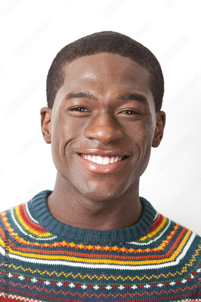 Obraz premium Portrait of happy young African American man in knitwear against white background