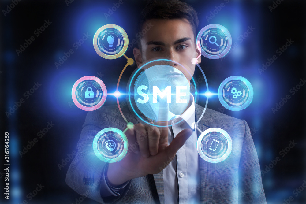 Business, Technology, Internet and network concept. Young businessman working on a virtual screen of the future and sees the inscription: Business, Technology, Internet and network concept. Young businessman working on a virtual screen of the future and sees the inscription: