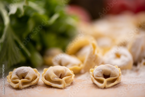 Tortellini or Tortelloni pasta on a flour dusted board