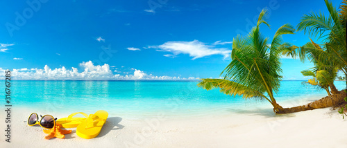 Fototapeta Naklejka Na Ścianę i Meble -  White sand beach, turquoise ocean, blue sky, clouds, palm tree over water, sunglasses, flip-flops and starfish. Maldives, perfect tropical landscape, ultra wide format, concept of summer vacation.