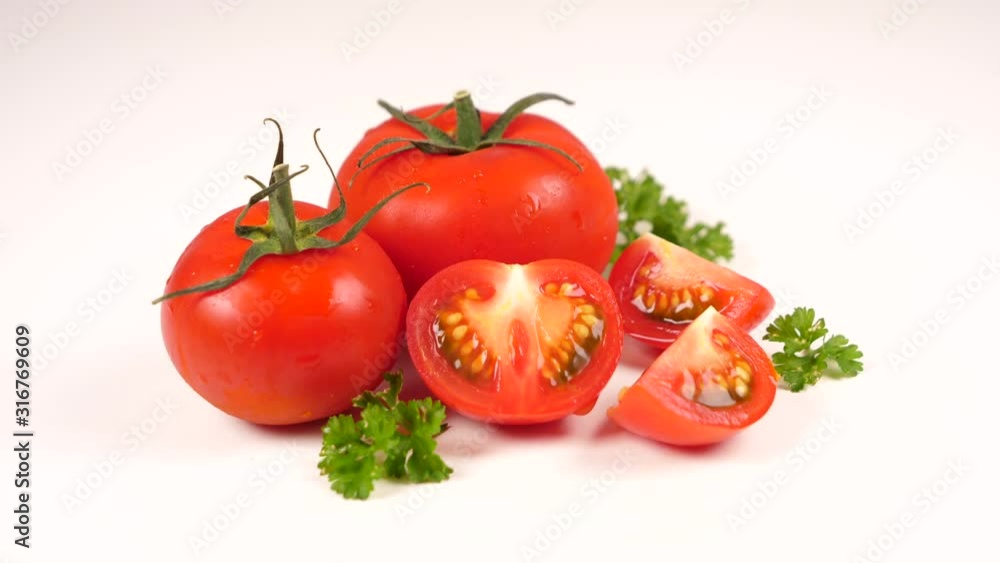 red tomato and parsley on white background red tomato and parsley on white background