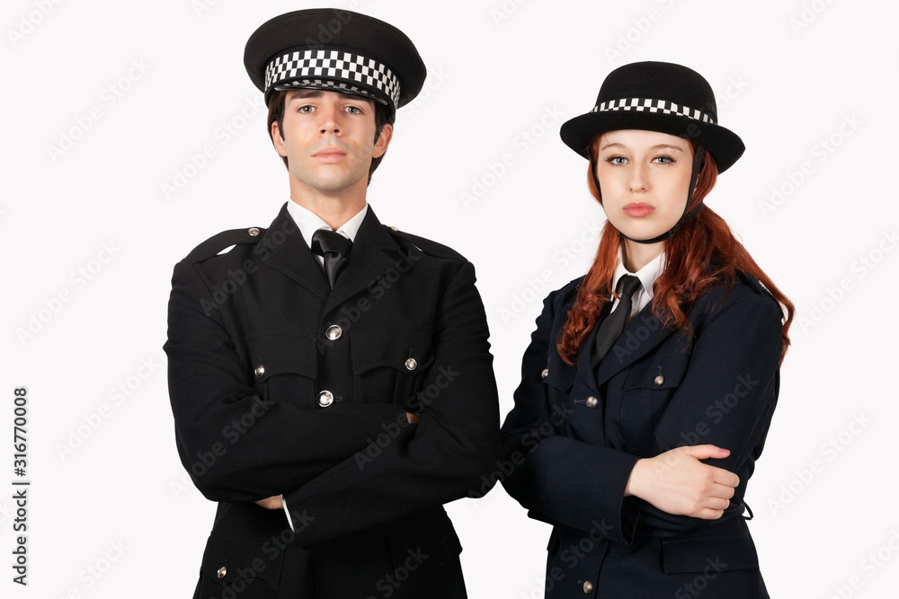 Portrait of confident police officers with arms crossed against white background Portrait of confident police officers with arms crossed against white background