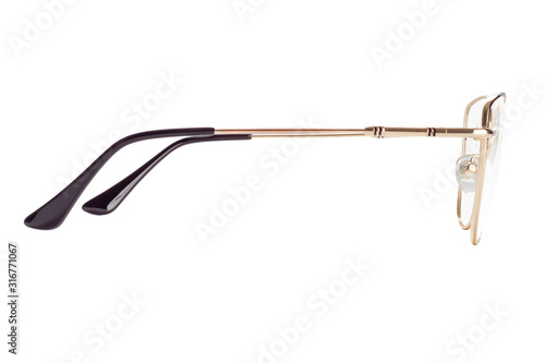 The side view of female eyeglasses in a golden frame isolated on white background