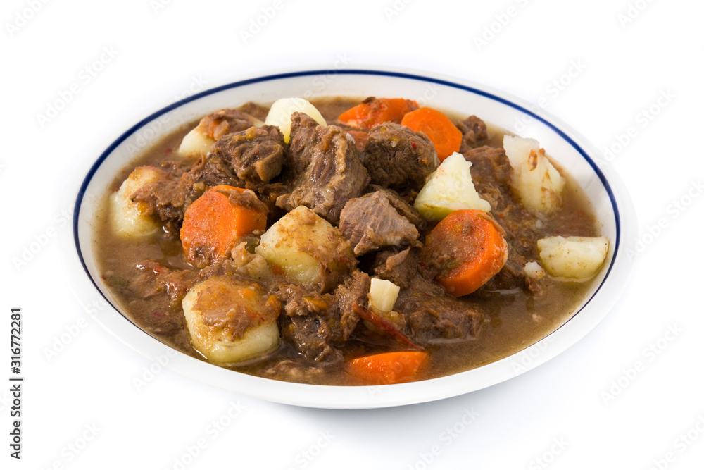 Irish beef stew with carrots and potatoes isolated on white background Irish beef stew with carrots and potatoes isolated on white background