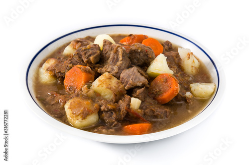 Irish beef stew with carrots and potatoes isolated on white background